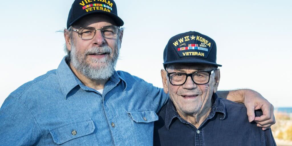 optical-aids-for-low-vision-1024x512 Senior men with glasses standing together looking at camera